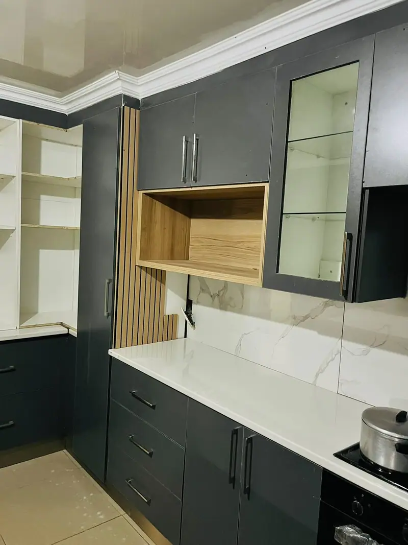 Charcoal wall cabinets with a glass door and an open timber shelf