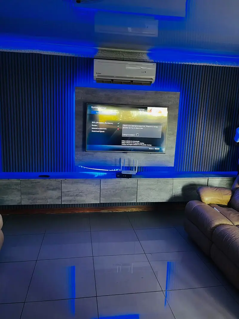 TV feature wall with fluted panelling and blue LED lighting