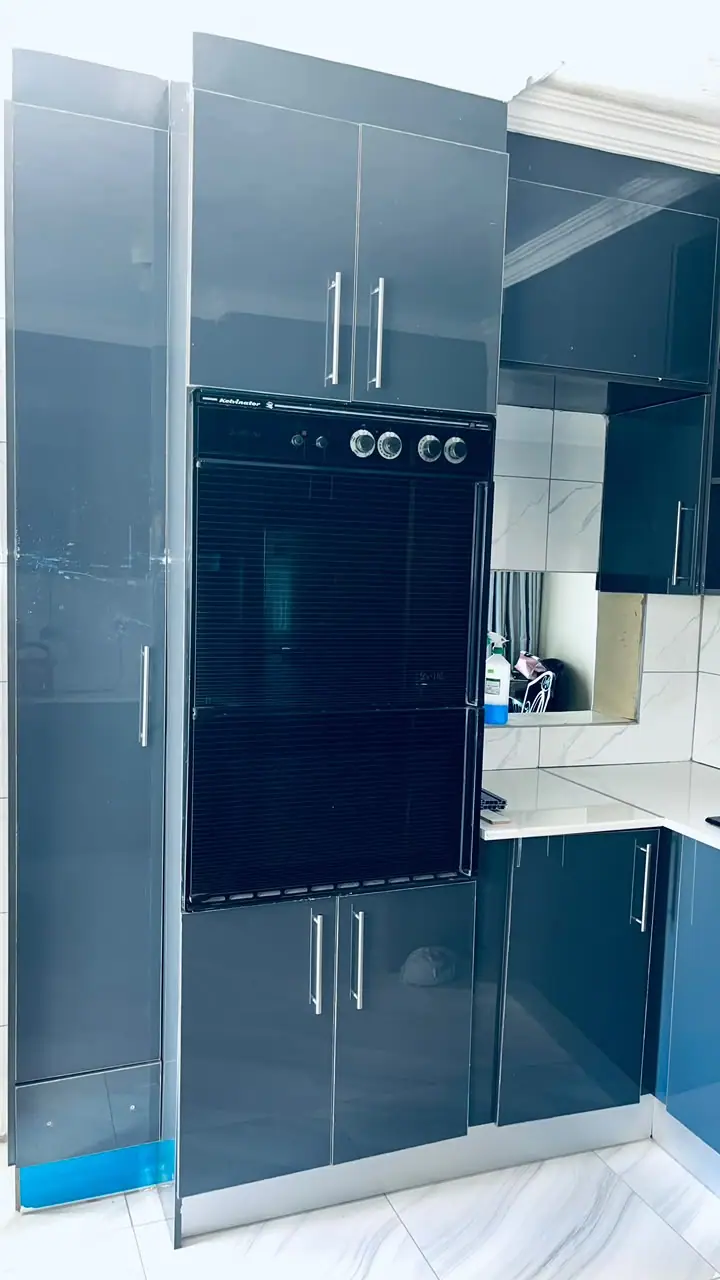 Tall navy gloss oven housing with chrome handles