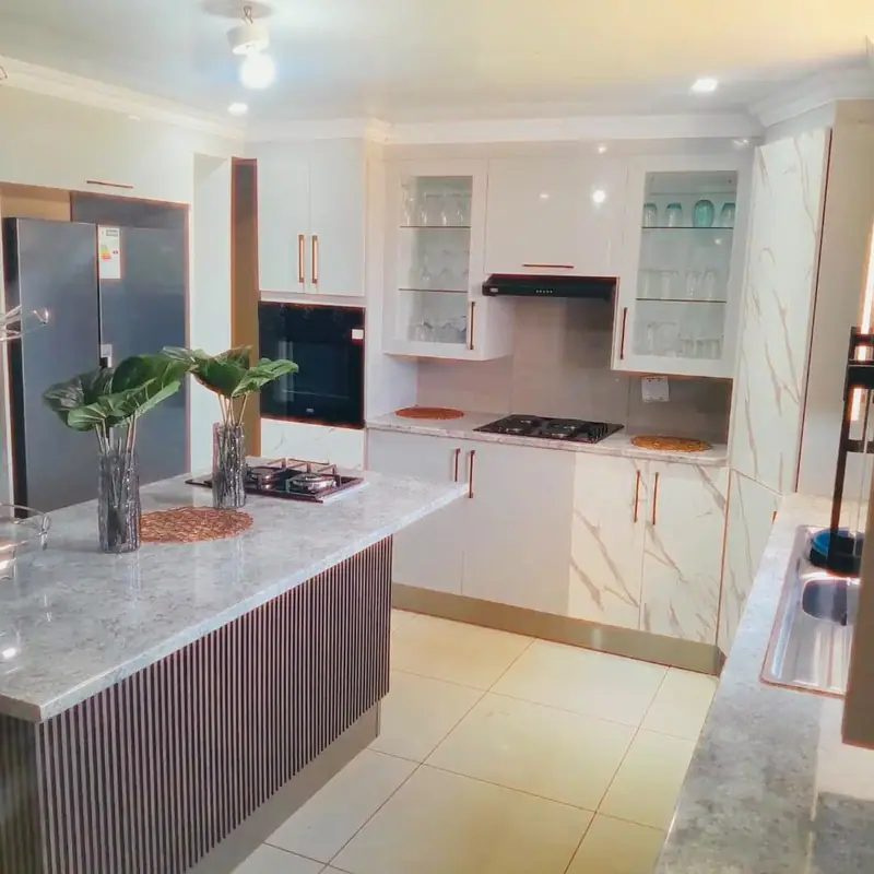 Kitchen with an island, built-in hob and glass-door wall cabinets