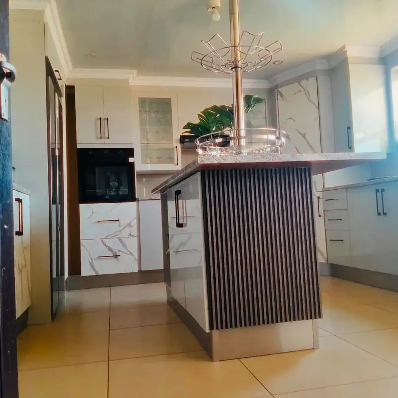 Fluted timber island panel in a white gloss kitchen