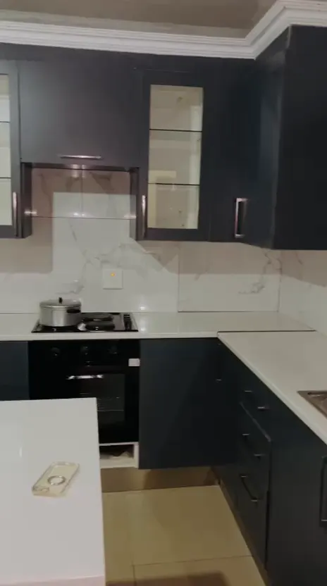 Still from a walk-through video of the charcoal and timber kitchen